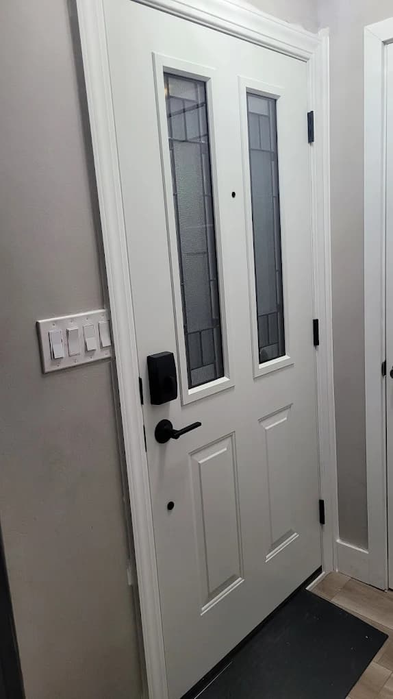 White fiberglass double-light entry door installed by Euro-Tech in the Midwest